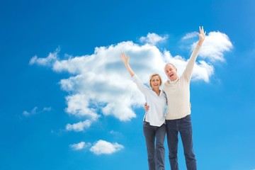 Composite image of happy mature couple cheering at camera