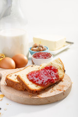 Healthy breakfast. Two slices of bread with jam on wooden table.