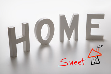 the word home written in white wooden letters 