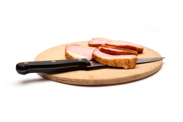Sliced meat on a wooden board. Photo.