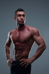 Fototapeta na wymiar Portrait of a handsome muscular man over gray background