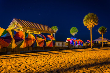 Palm trees and colorful beach umbrellas at night in Clearwater B