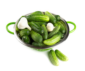 fresh cucumbers in a green colander