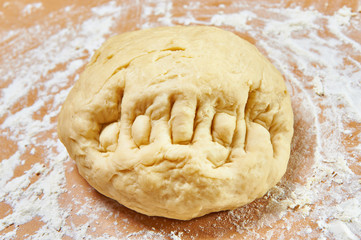 Knead dough on wooden table