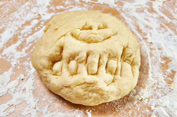 Funny knead dough on wooden table