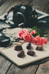 Vintage camera, old photos and roses