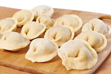 Dumplings on cutting board in kitchen
