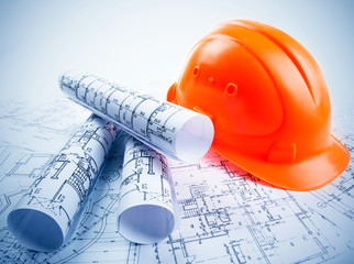 Architectural blueprint rols and helmet