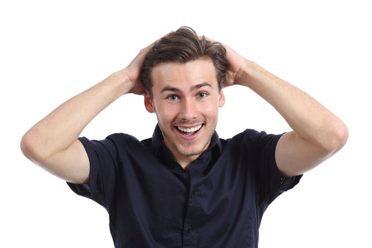 Surprised happy man smiling with hands on head