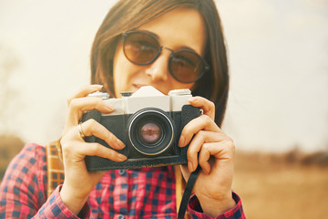 Traveler woman takes photographs with vintage photo camera