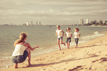 Happy family playing on the beach at the day time.