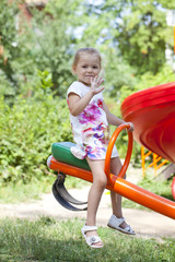 Adorable little girl having fun on a swing outdoor