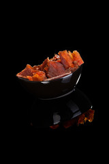 Beef jerky isolated on black.