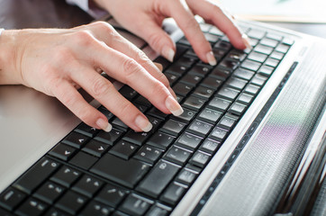 Businesswoman typing on a laptop