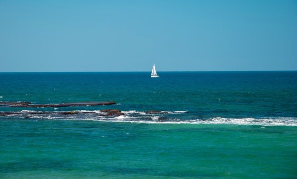 Seascape with a sailing boat on the horizon