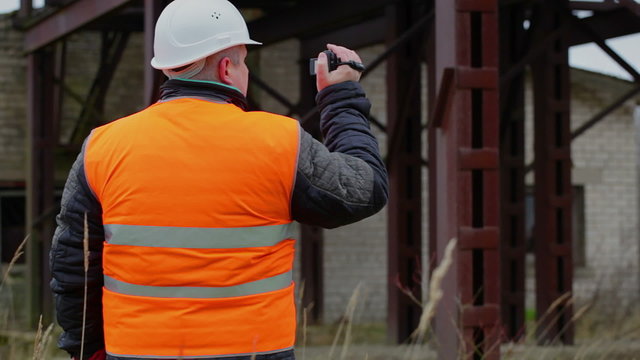 Building inspector filmed with camcorder in factory