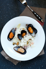 Italian mussels with rice in white plate
