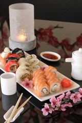 Sushi with candles and flowers
