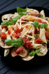 Close-up of pasta alla Norma, italian dish with eggplant