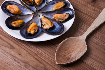 prepared mussels on wooden background