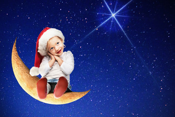 Little girl with santa hat sitting on the moon