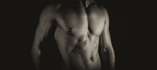 Fototapeta na wymiar Unrecognizable muscular male body. Black and white.