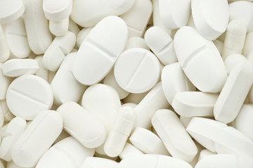 Fototapeta na wymiar many white drugs pills shapes texture background