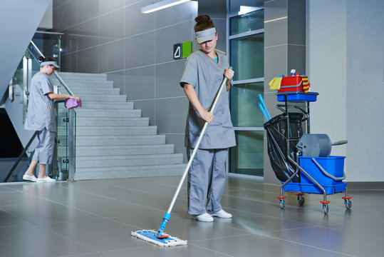 worker cleaning floor with machine
