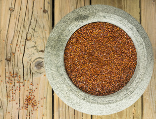 red quinoa in a stone bowl