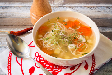 Chicken broth with vermicelli, vegetables and herbs