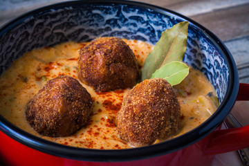French bean sauce with meatballs and brown bread, closeup