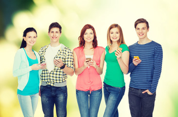 smiling students with smartphones