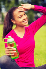 smiling teenage girl showing bottle