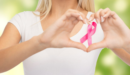 close up of woman and pink cancer awareness ribbon