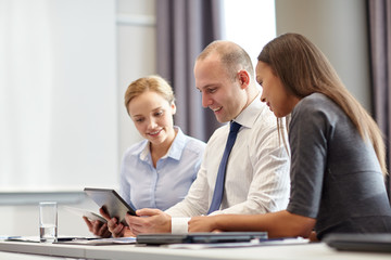 smiling business people with tablet pc in office