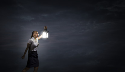 Businesswoman with lantern