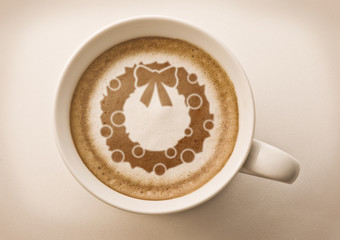 Christmas wreath drawing on latte art coffee cup top view