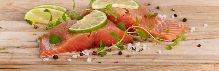 Fresh salmon fillet with oregano and lime slices