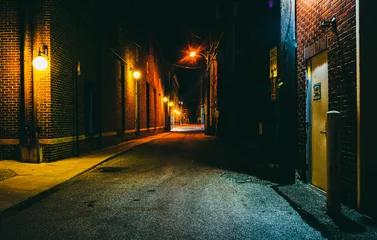 Zelfklevend Fotobehang Dark alley at night in Hanover, Pennsylvania. © jonbilous