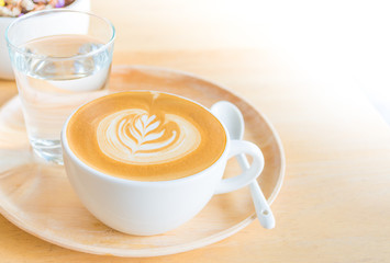 A Latte Coffee art on the wooden desk.