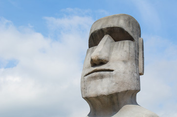 Stone sculpture of a Moai statue.