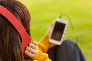 Close up of woman enjoying music in park