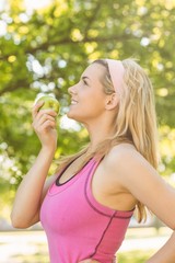 Fit blonde holding green apple