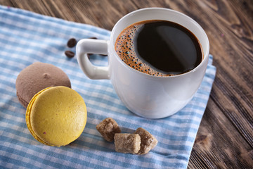 Cup of coffee and french macaron.