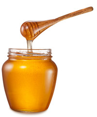Honey flowing into glass jar. File contains clipping paths.