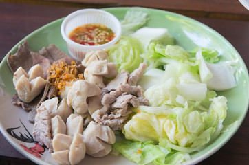 Meatballs stewed with vegetables on complex background