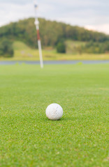 golf ball on lip of cup