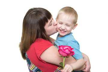 Mom kisses her son with a rose isolated on a white background