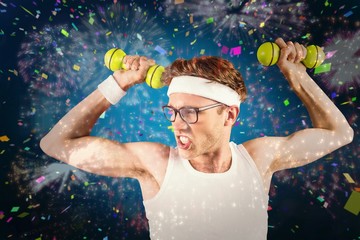 Geeky hipster posing in sportswear with dumbbells