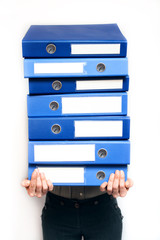 Stressed out female white collar professional with folders